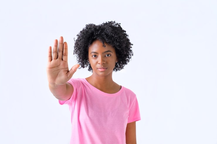 colombian-girl-with-afro-hair-with-hand-forward-with-stop-gesture-pink-tshirt-white-background_163068-1477